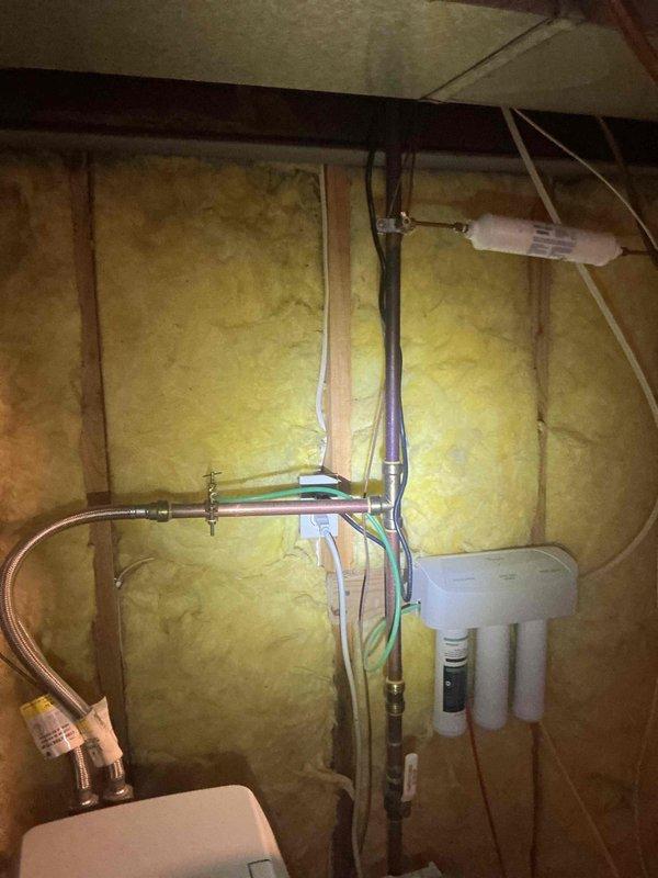Responded to refrigerator water line leak caused by improperly tightened connection. Identified problematic pierce valves on both the reverse osmosis system and refrigerator supply lines. Replaced pierce valves with tee fittings and quarter-turn angle stops for improved shutoff capability and future serviceability. Removed inline filter from refrigerator supply line, disconnected and removed shark bite fittings, and reconnected water line to refrigerator with proper connections to eliminate leak.
