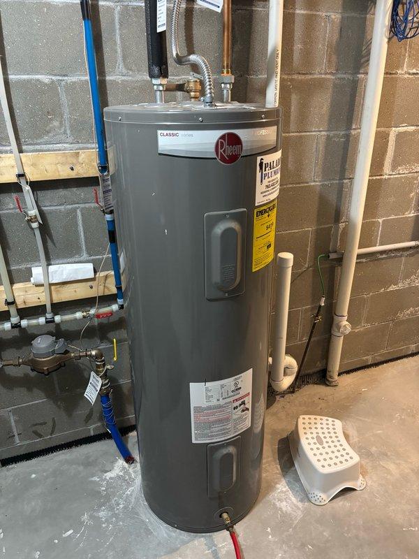 Responded to service call for 45-gallon electric Rheem water heater experiencing rapid hot water depletion and short cycling from hot to cold after only a few minutes of use. Upon arrival, proceeded to utility room to diagnose the issue. Performed electrical testing on both heating elements and thermostats, which all tested within normal operating parameters. Removed cold water inlet connection to inspect the dip tube assembly. Inspection revealed the dip tube had broken off, causing incoming cold water to mix directly with hot water at the top of the tank rather than being directed to the bottom, resulting in the reported symptoms. Documented findings with photographs of the water heater installation and electrical panel. Prepared estimate for dip tube replacement, which will require ordering the part for subsequent installation upon approval.