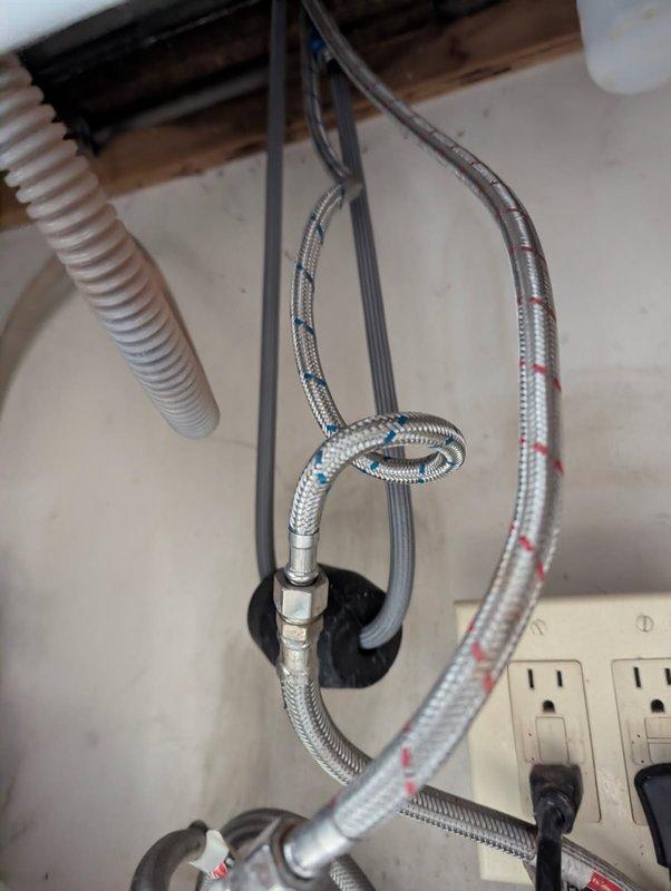 Responded to water leak under kitchen sink and identified pinhole leak in supply line. Inspected braided flexible water supply lines and plumbing connections, documented existing conditions with photos, and provided replacement estimates to address the failed component.