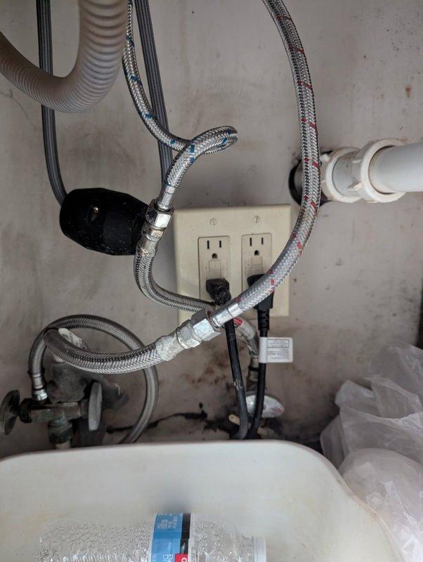 Responded to water leak under kitchen sink and identified pinhole leak in supply line. Inspected braided flexible water supply lines and plumbing connections, documented existing conditions with photos, and provided replacement estimates to address the failed component.