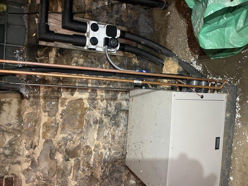 Responded to service call for furnace that would not shut off. Thermostat wire had been severed during recent basement construction work when support beam was installed, causing system control failure. Located damaged wire section, repaired broken thermostat wire connections, and properly re-stapled wiring along pathway to prevent future damage. Tested and verified proper operation of both heating and cooling cycles on heat pump system. Unit now cycling correctly with thermostat commands.