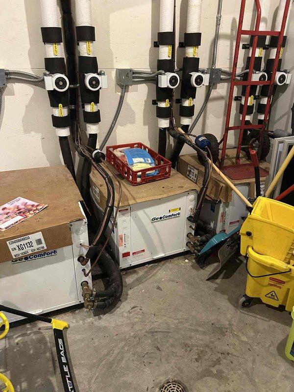 Responded to multiple geothermal HVAC units not operational in commercial facility. Found loop field low on water and repressurized system to 20 psi. Operating room unit had locked out due to failed blower motor, which was replaced to restore functionality. Infloor geothermal unit had triggered freeze protection lockout; preliminary diagnostics indicate probable low refrigerant charge requiring follow-up service visit for complete evaluation and repair. Monitored operating room unit after repairs to confirm proper operation.