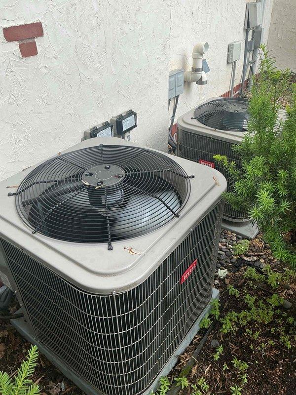 Completed scheduled maintenance tune-up on two 5-year-old residential air conditioning systems under membership agreement. Performed comprehensive inspection of all components, verified proper operation and performance within manufacturer specifications, and confirmed refrigerant charge levels were adequate on both units. Cleaned dirty outdoor condenser coils by rinsing to restore optimal heat transfer efficiency. Both systems tested fully operational upon completion.