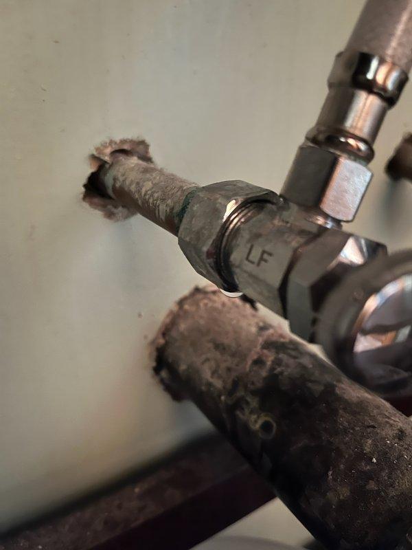 Responded to upstairs bathroom leak originating from under the vanity sink. Upon inspection, identified a faulty hot water angle stop as the source of the leak, which continued even when the hot water supply was shut off. Removed the corroded, deteriorated angle stop and installed a new replacement valve to restore proper function and eliminate the water leak.