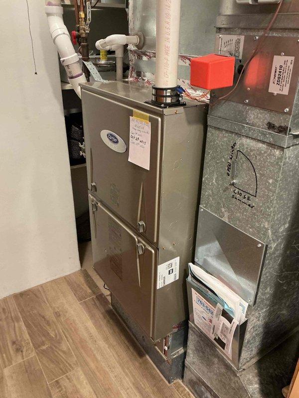 Performed comprehensive preventative maintenance inspection on 16-year-old Carrier air conditioning system. Verified contactor and capacitor operation within normal parameters. Inspected outdoor coil condition, noting minor dirt accumulation; cleaning deferred due to lack of water source availability. Cleaned electrical compartment of debris and dust. Verified refrigerant charge at proper levels with no leaks detected. Measured compressor and condenser fan motor amp draws, confirming all readings within manufacturer specifications. Inspected furnace filter, finding it in acceptable condition. Verified control board functionality with no error codes present. Inspected indoor evaporator coil and blower wheel assembly, both found clean with no buildup. Measured supply and return air temperatures, confirming 18-degree temperature split within optimal range. System operating efficiently with no deficiencies identified and no repairs or recommendations necessary at this time.