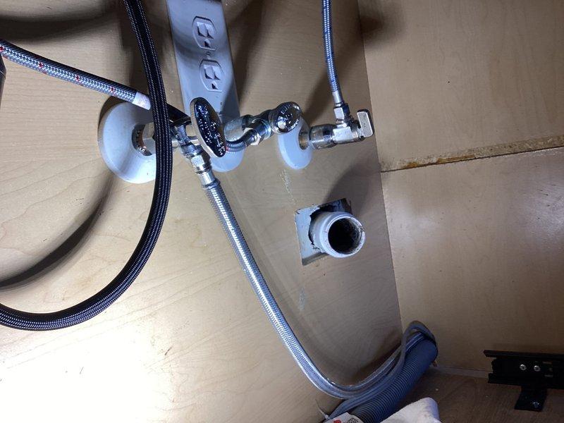 Installed customer-provided garbage disposal and kitchen faucet beneath kitchen sink. Connected braided stainless steel supply lines to angle stop valves with proper escutcheons at wall penetrations. Installed dishwasher supply line to existing water connection. Verified all connections for proper operation and checked for leaks. All fixtures tested and functioning correctly upon completion.