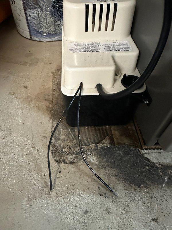 Responded to safety concern regarding exposed wiring at condensate pump from recent heat pump installation. Upon inspection, identified two loose wires extending from condensate pump unit and making contact with floor, creating potential electrical hazard. Secured both wires with wire nuts for proper termination and used zip ties to fasten wiring away from floor contact. Documented installation discrepancy for management review via install correction form to ensure quality control protocols are followed on future installations.