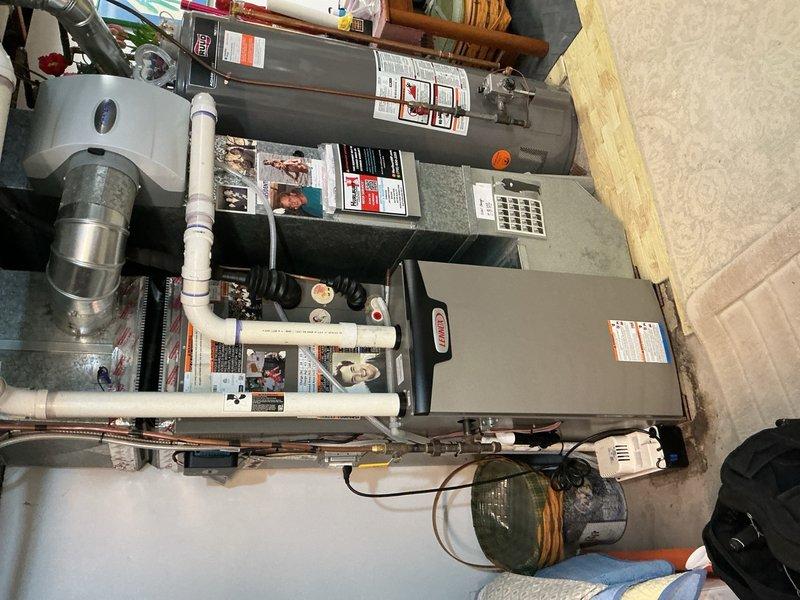 Responded to safety concern regarding exposed wiring at condensate pump from recent heat pump installation. Upon inspection, identified two loose wires extending from condensate pump unit and making contact with floor, creating potential electrical hazard. Secured both wires with wire nuts for proper termination and used zip ties to fasten wiring away from floor contact. Documented installation discrepancy for management review via install correction form to ensure quality control protocols are followed on future installations.