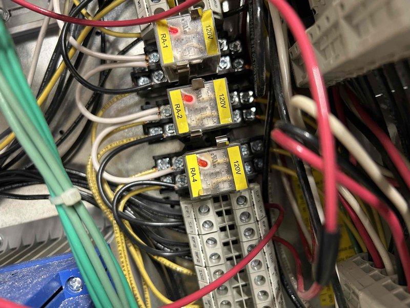 Responded to callback for exhaust hood interlock fault created during previous site visit. Diagnosed MUA interlock issue preventing damper operation on makeup air unit. Investigated VFD power loss and confirmed absence of 120V supply from control panel to drive. Inspected relay contactors RA-1, RA-2, and RA-4 in electrical control panel and associated terminal block wiring. Documented equipment conditions and coordinated follow-up requirements to restore full system operation and prevent weekend shutdown.