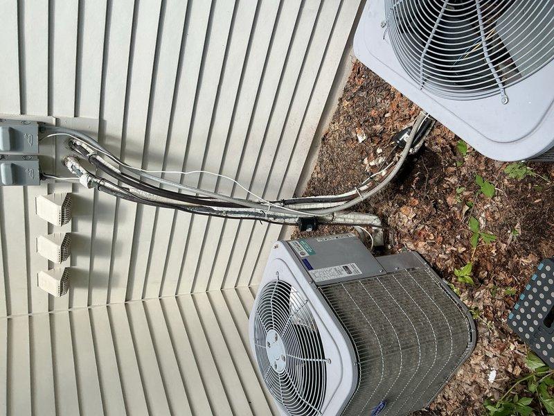 Completed annual spring cooling maintenance on two residential air conditioning systems. Performed comprehensive tune-up including cleaning outdoor condenser units, verifying refrigerant charge levels, and inspecting all system components. Both systems operating properly with no functional concerns identified. Noted that exterior refrigerant line insulation on both units requires replacement to maintain optimal energy efficiency.