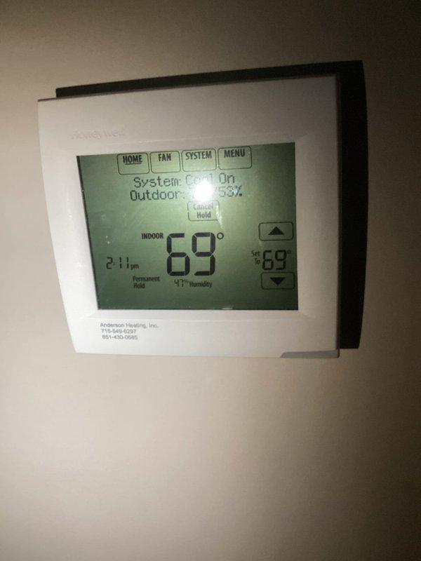 Responded to no cool complaint on 8-year-old system. Upon arrival, verified main floor thermostat holding at 69°F while basement thermostat read 65°F in off position. Conducted thorough inspection of return air system throughout residence. Found inadequate return air flow with disproportionate return vent distribution—large returns located in basement with minimal returns on main living levels. Tested and confirmed dampers operational. Diagnosed probable return air imbalance causing conditioned air to short-cycle through basement rather than properly circulating through main living areas. Documented findings with photos of basement ductwork, copper refrigerant lines, and thermostat display. Advised customer of return air distribution issue affecting system performance and cooling efficiency on upper levels.