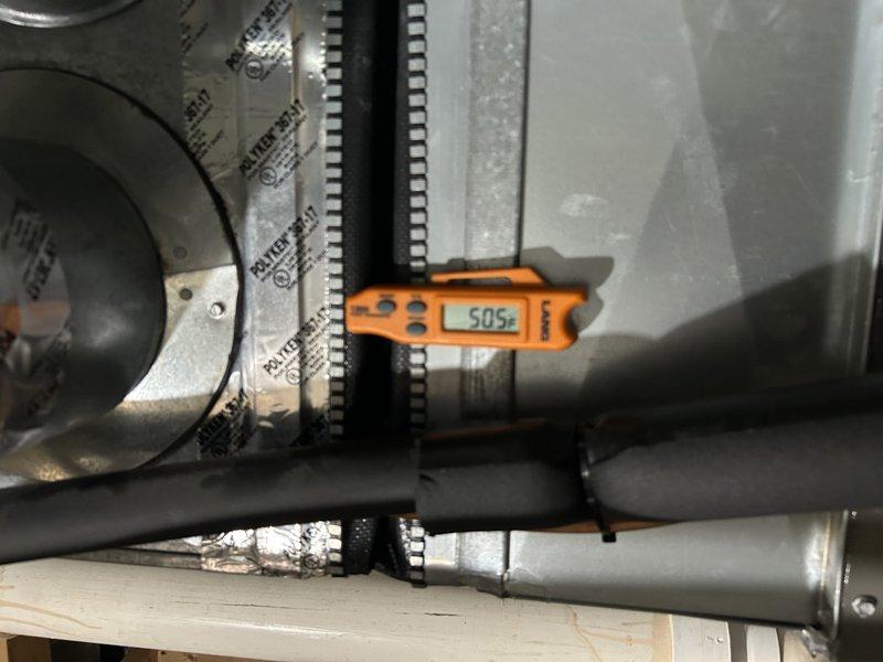 Performed comprehensive air conditioning tune-up on 2-year-old system. Identified humidifier damper in winter position causing excessively cold return air; adjusted damper to proper setting and achieved appropriate 20-degree temperature differential. Tested system operation, verified condensate drain clear, performed condenser coil cleaning, and inspected all components with satisfactory results. Noted air filter nearing end of service life and recommended replacement at next interval.
