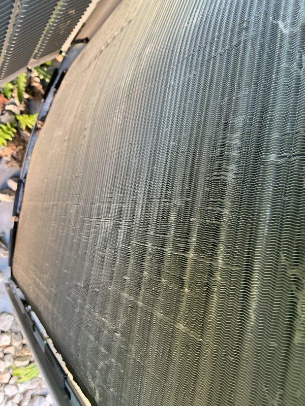 Completed annual maintenance visit on 4-year-old air conditioning system as part of membership agreement. Performed comprehensive AC tune-up including system inspection, testing of electrical components and controls, and evaluation of condenser unit performance. Observed condenser coil accumulating debris and environmental buildup on exterior fins, with organic material lodged along unit edges; noted darker discoloration on portions of coil indicating dirt and dust accumulation. Inspected interior electrical components, circuit boards, wiring harnesses, and heat exchanger fins, all found in working condition with no signs of damage or deterioration. System operating within normal parameters at time of service; advised ongoing monitoring of condenser coil cleanliness to maintain optimal efficiency.