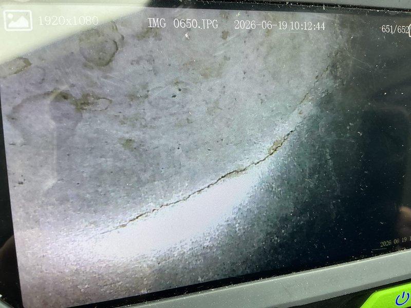 Performed comprehensive HVAC inspection on 27-year-old forced air gas furnace and air conditioning system for new homeowner. During furnace tune-up and inspection, discovered heat exchanger with multiple cracks in chambers on both sides of high limit switch, resulting in carbon monoxide leakage during operation. Determined furnace unsafe for operation with all original mechanical components showing signs of failure. AC system inspection revealed complete loss of refrigerant charge, indicating active leak in system containing obsolete R22 refrigerant. Documented findings with inspection camera photography showing heat exchanger damage and system conditions. Scheduled equipment replacement estimate for new furnace and air conditioning system.
