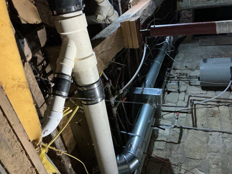 Responded to a no-flush toilet complaint and discovered the main drainage line in the basement was severely obstructed with approximately five gallons of accumulated toilet paper. Upon inspection, identified a deteriorated section of cast-iron pipe with previous repair couplings that was causing recurring blockages due to rough interior surfaces and structural degradation. Disassembled the existing repair couplings, successfully cleared the obstruction, and restored proper drainage flow. Advised that the compromised cast-iron section requires replacement to prevent future blockages, as the degraded pipe condition continues to catch debris and will result in ongoing maintenance issues until permanently addressed with new piping.
