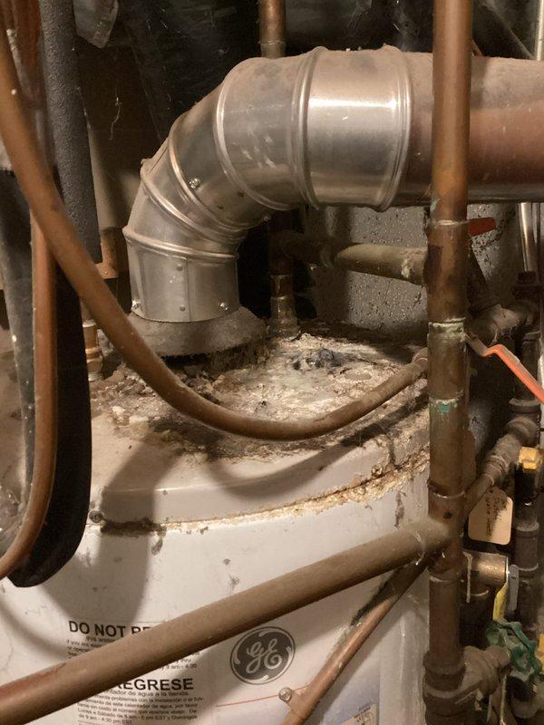 Responded to no-cool complaint on 15-year-old air conditioning system with outdoor unit tripping circuit breaker. Upon inspection, discovered rodent damage to compressor wiring with visible evidence of mice intrusion into the condenser unit. Performed electrical diagnostics and measured amperage draw from compressor, which exceeded manufacturer specifications and was causing the breaker trips. The compromised wiring and out-of-range electrical draw indicate significant compressor deterioration consistent with the unit's age and previous recurring service history. During site inspection, also identified an active water leak at the base of the water heater that poses risk of water damage and potential mold growth requiring prompt attention. System condition reflects age-related wear and declining performance typical of equipment beyond its expected service life.