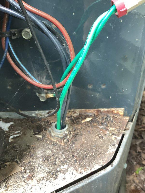 Responded to no-cool complaint on 15-year-old air conditioning system with outdoor unit tripping circuit breaker. Upon inspection, discovered rodent damage to compressor wiring with visible evidence of mice intrusion into the condenser unit. Performed electrical diagnostics and measured amperage draw from compressor, which exceeded manufacturer specifications and was causing the breaker trips. The compromised wiring and out-of-range electrical draw indicate significant compressor deterioration consistent with the unit's age and previous recurring service history. During site inspection, also identified an active water leak at the base of the water heater that poses risk of water damage and potential mold growth requiring prompt attention. System condition reflects age-related wear and declining performance typical of equipment beyond its expected service life.