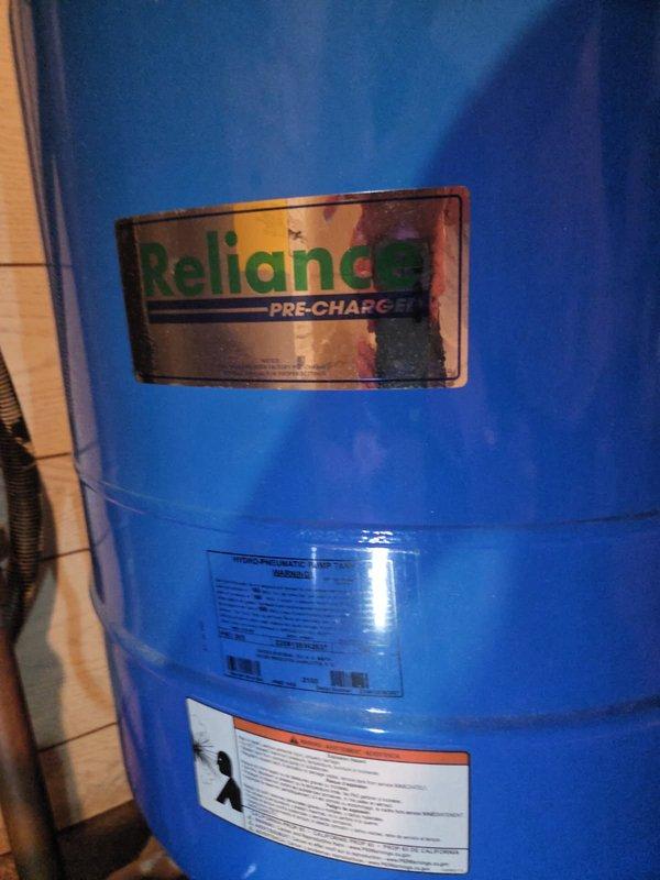 Responded to low/no water pressure concern with suspected pressure tank bladder failure. Upon inspection, determined the Reliance pressure tank, bladder, and all associated fittings were in proper working condition with no defects found. Addressed customer concerns regarding brown water discoloration, explained this is typical in well water systems due to iron content, and provided estimate for iron filter and sediment filter installation to improve water quality and reduce iron staining.