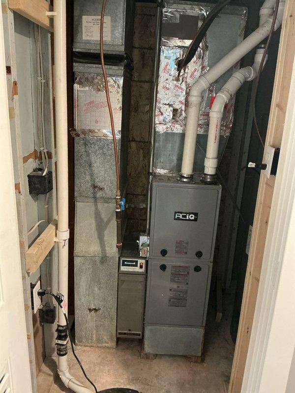 Completed comprehensive tune-up and inspection on 2-year-old furnace and air conditioning system. Cleaned dirty furnace blower wheel and inspected all system components. Identified several issues requiring attention: non-functional electronic air filter (recommended replacement with 16x25x4 paper filter with quarterly changes), missing condensate drain line from furnace condensate trap causing water to leak directly into furnace cabinet, and AC condensate line with no accessible discharge point due to installation behind washing machine and beneath built-in cabinetry. Cleaned dirty outdoor AC coils. Verified all other system components operating within manufacturer specifications. Provided recommendations for condensate drainage solutions including tee connection to existing line, new line to sump pump, or installation of condensate pump with estimate to follow.