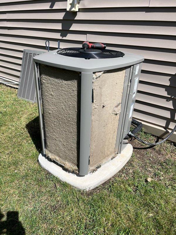 Performed comprehensive AC tune-up on residential cooling system. Upon inspection, discovered outdoor condenser unit completely plugged with heavy accumulation of dirt, dust, and fibrous debris on exterior panels and coils. Removed panels from outdoor unit and thoroughly rinsed and cleaned condenser coils to restore proper airflow. Inspected electrical components and connections inside outdoor unit—all found to be in good working condition. Proceeded indoors to check air filter, which had been recently replaced by homeowner. Verified evaporator drain line was draining properly with no blockages. Started system and allowed adequate run time for unit to dry out following cleaning. Confirmed system operation with 22-degree temperature split across evaporator coil, indicating proper cooling performance. Advised homeowner on importance of regular maintenance schedule to prevent future coil blockage and maintain system efficiency.