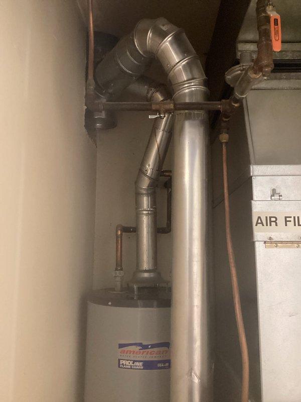 Responded to no hot water complaint on 10-year-old American ProLine tanked water heater. Diagnosed pilot light failure where flame would ignite when button depressed but immediately extinguished upon release. Tested thermopile output and measured 700mv DC, which indicated adequate thermocouple function. Determined Honeywell gas control valve was faulty and preventing pilot from remaining lit despite proper thermopile voltage. Provided estimate for gas valve replacement versus full water heater replacement and awaited approval for repair.