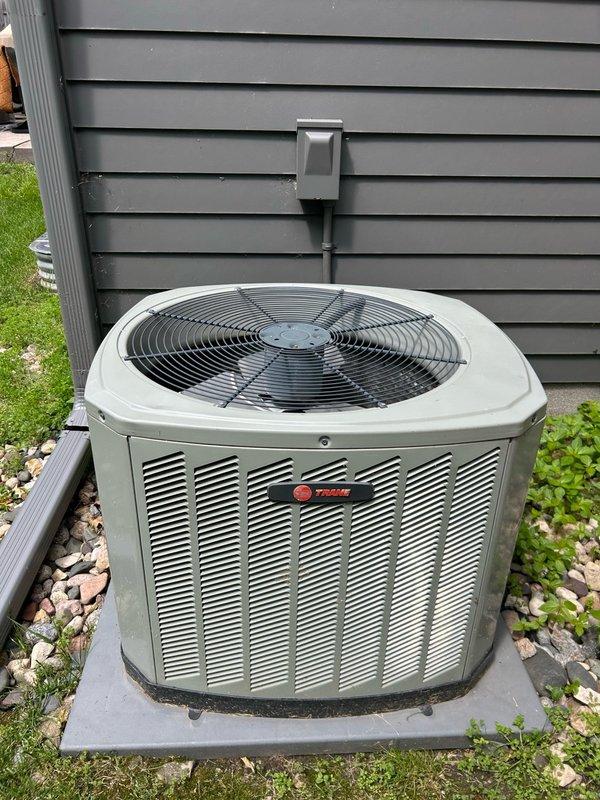 Performed comprehensive AC tune-up and system inspection on Trane air conditioning system. Recovered 5 oz of refrigerant and verified proper operation with 78°F outdoor ambient temperature. Corrected fan motor bracket rattle by repositioning and bending the detached support bar to secure the motor and eliminate noise. Conducted thorough inspection of furnace, condensate drain, heat exchanger, and evaporator coil. Discovered cracked heat exchanger and red-tagged the unit for safety; showed defect to homeowner at equipment location.

Investigated reported short cycling issue where outdoor unit would run only 5-10 minutes at a time, shut off, and fail to maintain adequate cooling. Cleaned condenser coils and washed outdoor unit to remove accumulated debris and improve airflow. Checked refrigerant charge and determined system appears to be overcharged by approximately one pound. Refrigerant recovery and charge verification required to obtain accurate operating readings and restore proper s