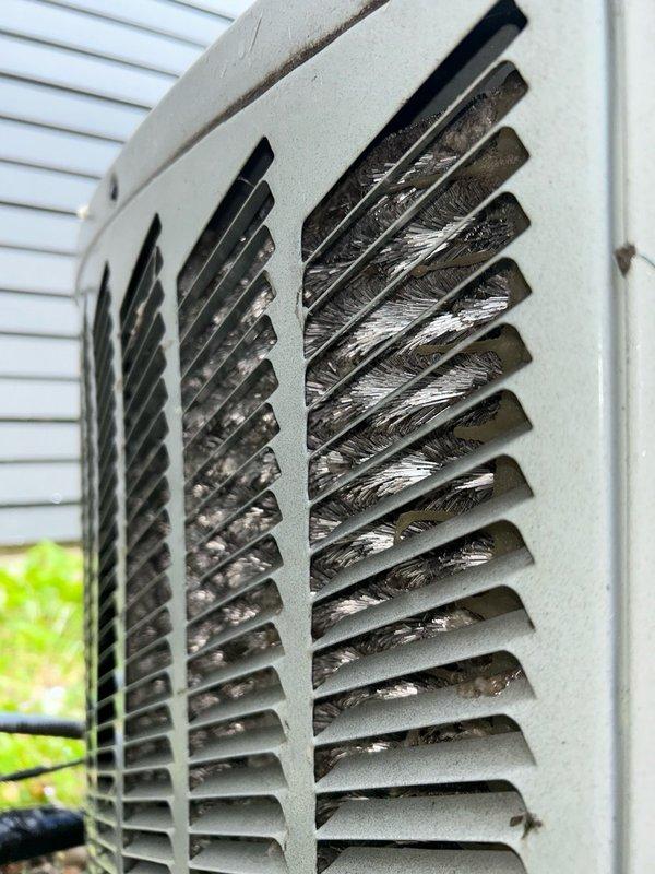 Performed comprehensive AC tune-up and system inspection on Trane air conditioning system. Recovered 5 oz of refrigerant and verified proper operation with 78°F outdoor ambient temperature. Corrected fan motor bracket rattle by repositioning and bending the detached support bar to secure the motor and eliminate noise. Conducted thorough inspection of furnace, condensate drain, heat exchanger, and evaporator coil. Discovered cracked heat exchanger and red-tagged the unit for safety; showed defect to homeowner at equipment location.

Investigated reported short cycling issue where outdoor unit would run only 5-10 minutes at a time, shut off, and fail to maintain adequate cooling. Cleaned condenser coils and washed outdoor unit to remove accumulated debris and improve airflow. Checked refrigerant charge and determined system appears to be overcharged by approximately one pound. Refrigerant recovery and charge verification required to obtain accurate operating readings and restore proper s
