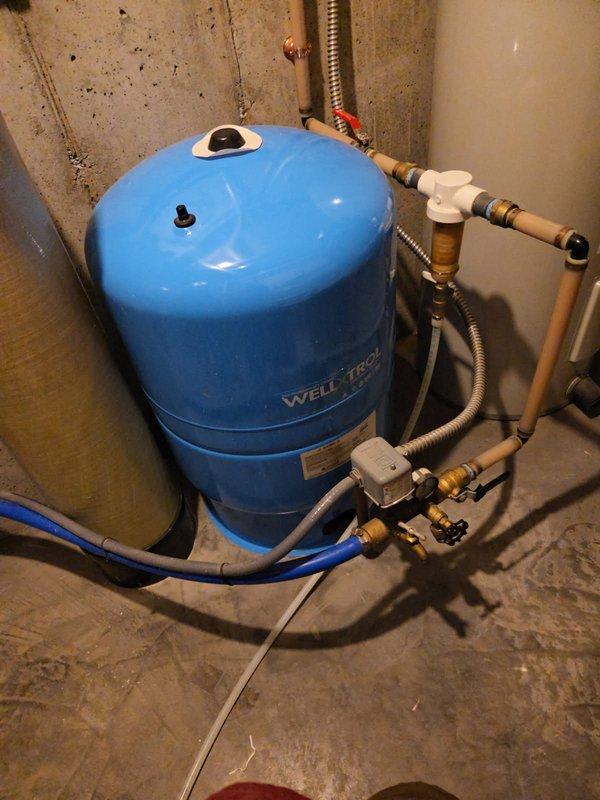 Responded to water pump short cycling issue. Inspected Well-X-Trol pressure tank, associated plumbing connections, pressure switch, and Culligan water softener system. All interior components, valves, fittings, and controls tested and found operating within normal parameters. Determined short cycling issue originates from well system components outside scope of indoor plumbing equipment. Advised customer to contact well installation contractor for further diagnosis and repair of well pump or underground components causing cycling malfunction.