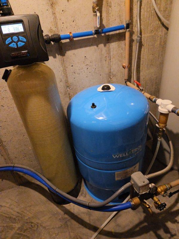 Responded to water pump short cycling issue. Inspected Well-X-Trol pressure tank, associated plumbing connections, pressure switch, and Culligan water softener system. All interior components, valves, fittings, and controls tested and found operating within normal parameters. Determined short cycling issue originates from well system components outside scope of indoor plumbing equipment. Advised customer to contact well installation contractor for further diagnosis and repair of well pump or underground components causing cycling malfunction.