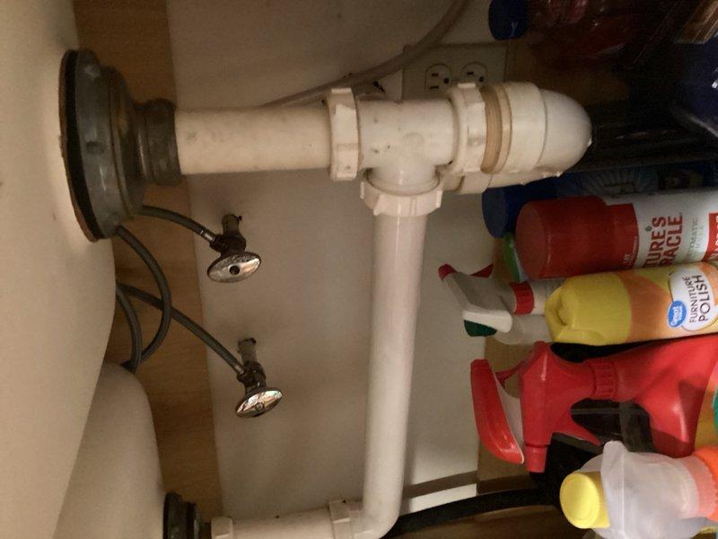 Completed plumbing inspection for friends and family service. Identified 50-gallon water heater actively leaking, unit is over 20 years old and beyond serviceable life. Documented existing plumbing conditions including under-sink drainage system and supply lines. Provided estimate for replacement 50-gallon water heater installation.