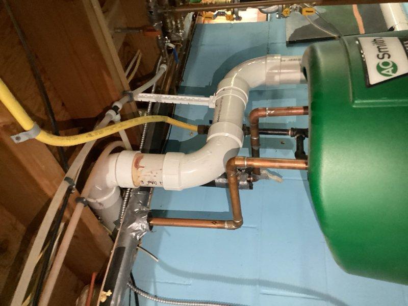 Responded to no hot water emergency call and diagnosed faulty igniter on A.O. Smith tanked water heater. Upon inspection, discovered the water heater was actively leaking and had been improperly integrated with the in-floor heating system, creating a critical failure situation. Due to the combination of failed igniter and active water leak compromising the unit's integrity, replacement was necessary to restore hot water service and ensure safe operation of both the domestic water heating and in-floor heating systems.