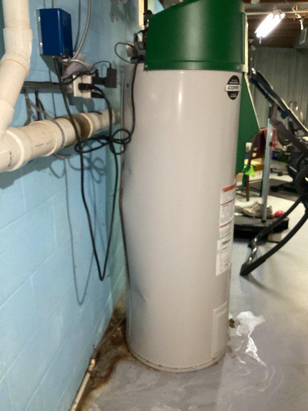 Responded to no hot water emergency call and diagnosed faulty igniter on A.O. Smith tanked water heater. Upon inspection, discovered the water heater was actively leaking and had been improperly integrated with the in-floor heating system, creating a critical failure situation. Due to the combination of failed igniter and active water leak compromising the unit's integrity, replacement was necessary to restore hot water service and ensure safe operation of both the domestic water heating and in-floor heating systems.