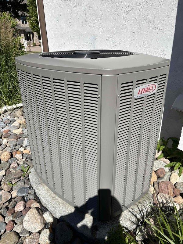 Performed comprehensive A/C maintenance on Lennox system with 410A refrigerant at 72-degree ambient temperature. Conducted full system inspection including filter, thermostat, temperature split, condenser unit, coils, motors, capacitors, compressor, refrigerant charge level, and condensate drain. Investigated customer concern regarding intermittent high-pitched rattling/clacking noise from condenser that occurred overnight but was not present during service visit. Inspected condenser fan assembly and housing for debris or foreign objects with no abnormalities found. Per customer request, evaluated evaporator coil accessibility and condition—coil found operational but access limited due to installation configuration above furnace. Inspected supply duct damper in underslab ductwork and confirmed manual adjustment capability via flathead screw mechanism; noted broken vane in main supply turning vent requiring future attention. Assessed outdoor condenser unit levelness and confirmed unit i