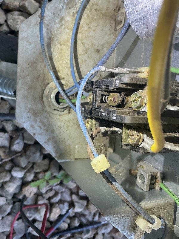 Completed annual AC maintenance on 21-year-old R22 system. During inspection, discovered dual capacitor reading out of specification and contactor showing significant pitting on contact points. Replaced defective dual capacitor and contactor to restore proper system operation and prevent potential failure.