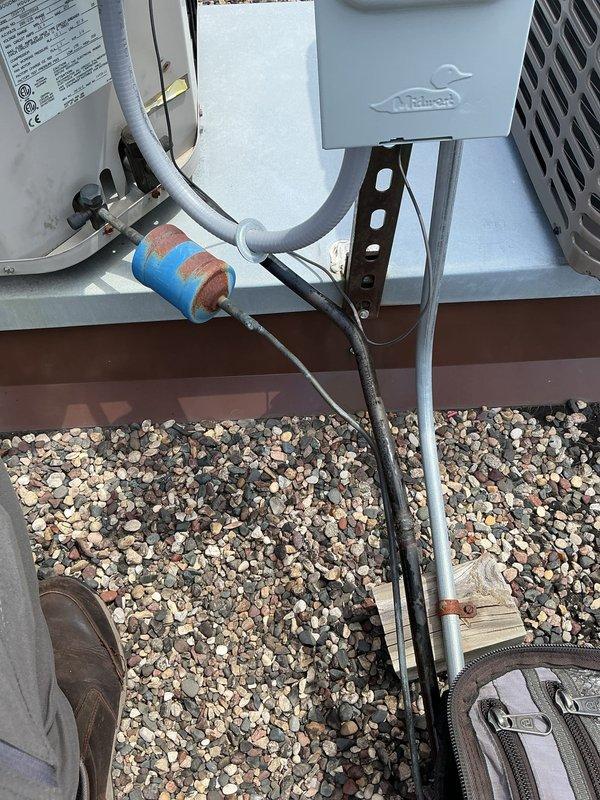 Performed comprehensive AC tune-up on 28-year-old rooftop unit accessed via front desk key coordination. System inspection revealed multiple failing components including capacitor, contactor, and condenser fan motor operating outside specifications. Compressor drawing high amperage and lineset insulation deteriorated, causing reduced efficiency and increased system workload. Unit operates on obsolete R22 refrigerant. Documented all failing components with photographic evidence showing electrical panel connections, outdoor condensing unit, and degraded pipe insulation on pebbled rooftop surface. System remains operational but requires replacement of capacitor, contactor, condenser fan motor, and lineset insulation to restore proper efficiency and prevent imminent failure.