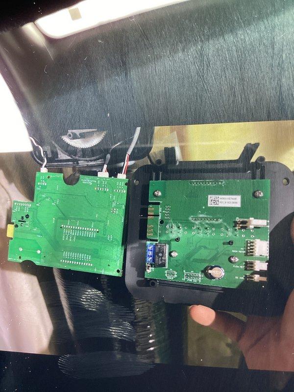 Completed warranty return trip to replace defective circuit board on water softener control head. Upon initial visit, identified faulty control board and ordered replacement part. Discovered incorrect part was received during this visit. Documented existing circuit board with LCD display, control buttons (SET CLOCK, NEXT, UP, DOWN, RE-GEN, TEST), and wire connections before removal. Removed defective board from metal housing and verified part specifications. Ordered correct replacement circuit board to complete repair on subsequent visit.