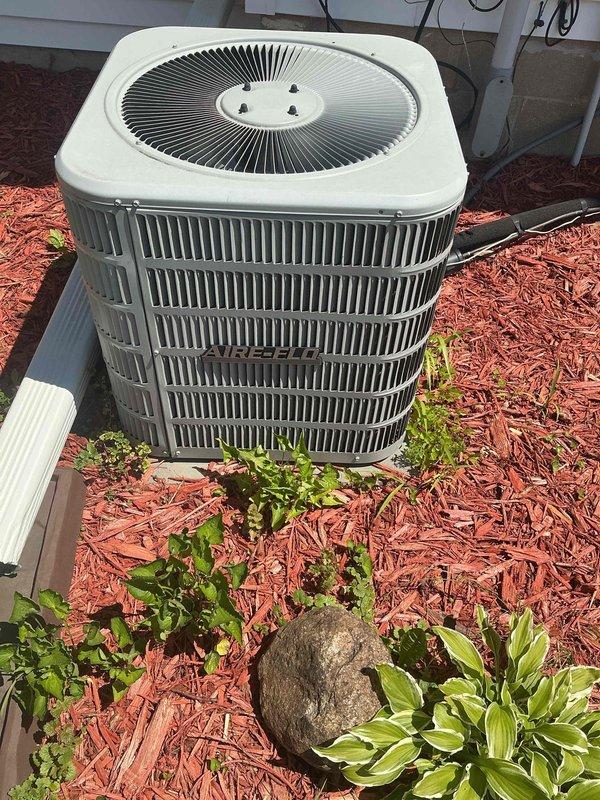 Responded to no cooling complaint on 9-year-old residential air conditioning system experiencing evaporator coil freeze-up after 20 minutes of operation. Upon arrival, confirmed system was low on refrigerant and verified outdoor condenser coil was clean with adequate airflow. Performed electrical diagnostics using multimeter to test system components and verify proper voltage. Documented outdoor unit condition and internal electrical measurements. System requires refrigerant charge and leak detection to restore proper cooling operation; presented repair options to address refrigerant loss and restore system functionality.