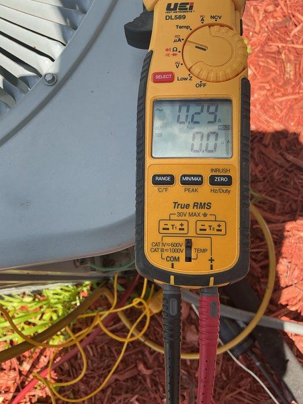 Responded to no cooling complaint on 9-year-old residential air conditioning system experiencing evaporator coil freeze-up after 20 minutes of operation. Upon arrival, confirmed system was low on refrigerant and verified outdoor condenser coil was clean with adequate airflow. Performed electrical diagnostics using multimeter to test system components and verify proper voltage. Documented outdoor unit condition and internal electrical measurements. System requires refrigerant charge and leak detection to restore proper cooling operation; presented repair options to address refrigerant loss and restore system functionality.