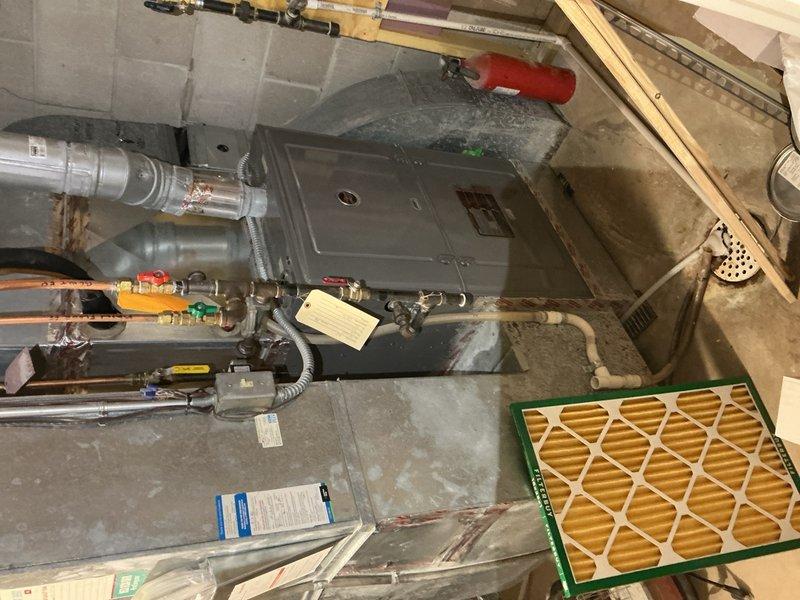 Completed comprehensive tune-up and maintenance on both furnace and air conditioning systems. The furnace exhibited heavy dust accumulation due to recent construction activity. Cleaned and dusted burners, scrubbed flame sensor, inspected heat exchanger for cracks or damage, and replaced air filter. Tested carbon monoxide levels which measured 23 ppm, within acceptable safety range. Verified condensation drain line is clear and draining properly. 

Performed exterior AC unit maintenance including coil rinse-down to remove debris and improve heat transfer efficiency. Inspected and tested capacitor for proper microfarad rating, examined contactor for pitting or wear, verified all electrical connections are secure, and checked refrigerant charge levels. All components operating within manufacturer specifications. Both heating and cooling systems are now optimized and ready for seasonal operation.