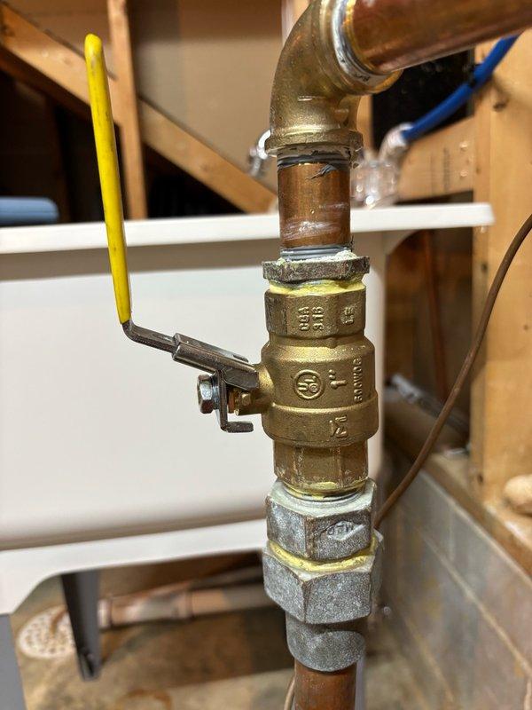 Replaced failed 1" threaded ball valve located before the water meter along with a 1" x 3/4" brass bushing. Coordinated with city water department for curb stop shut-off at 8am to facilitate safe replacement of main shut-off valve. After installation of new fittings, city personnel restored water service at the curb stop and system was pressure tested for leaks. Conducted thorough 10-minute inspection of all connections and joints with no leaks detected. Restored full water service to residence upon successful completion of testing.