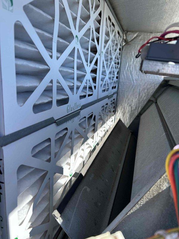 Performed comprehensive rooftop unit tune-up including replacement of air filters and inspection of all system components. Thermostat verified operational at 68°F with proper display function. Coil cleaning was not performed due to absence of exterior water source. All components checked and found operating within normal parameters with no deficiencies identified.