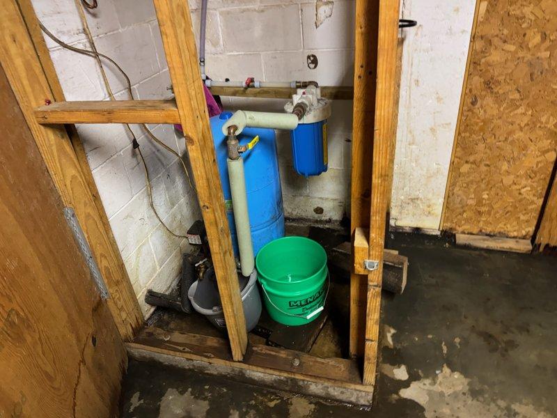 Responded to basement water leak caused by pinhole leak in copper pipe upstream of sediment filter and pressure tank system. Replaced defective ball valve and repaired compromised copper piping to restore proper water flow and eliminate active leak. System tested and verified operational with no additional leaks detected.