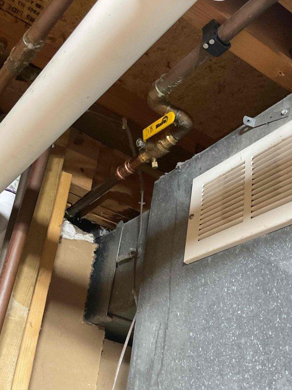 Rebuilt outdoor hose bibb assembly up to 3/4" with adapter (non-freeze proof configuration) to restore proper water flow and control at exterior spigot location. Accessed plumbing through closed wall, requiring opening of interior wall cavity to reach supply lines. Installed new ball valve up to 1" on copper supply line in ceiling joist space to provide improved shutoff capability for the exterior fixture. Replaced corroded spigot hardware and rebuilt valve assembly to eliminate leaks and restore full operational function. All connections tested and verified for proper operation with no leaks detected at valve body, threaded connections, or wall penetration points.