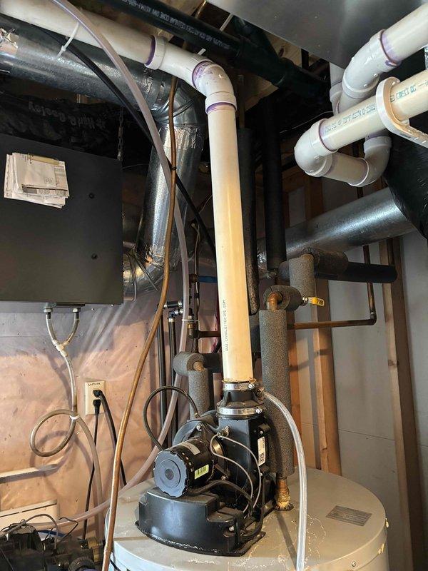 Completed comprehensive AC tune-up and maintenance on one R22 condenser unit with outside ambient temperature at 76 degrees. Performed full system inspection including air filter, thermostat operation, temperature split analysis, condenser unit, evaporator and condenser coils, blower motor, capacitors, compressor function, refrigerant charge level, and condensate drain line. All AC system components tested and found operating within normal parameters at time of service. During inspection of mechanical room, identified active water leak from residential water heater tank with visible moisture accumulation and water pooling. Recommended immediate water heater replacement due to tank failure and scheduled follow-up appointment for comfort advisor to provide replacement quote and options.