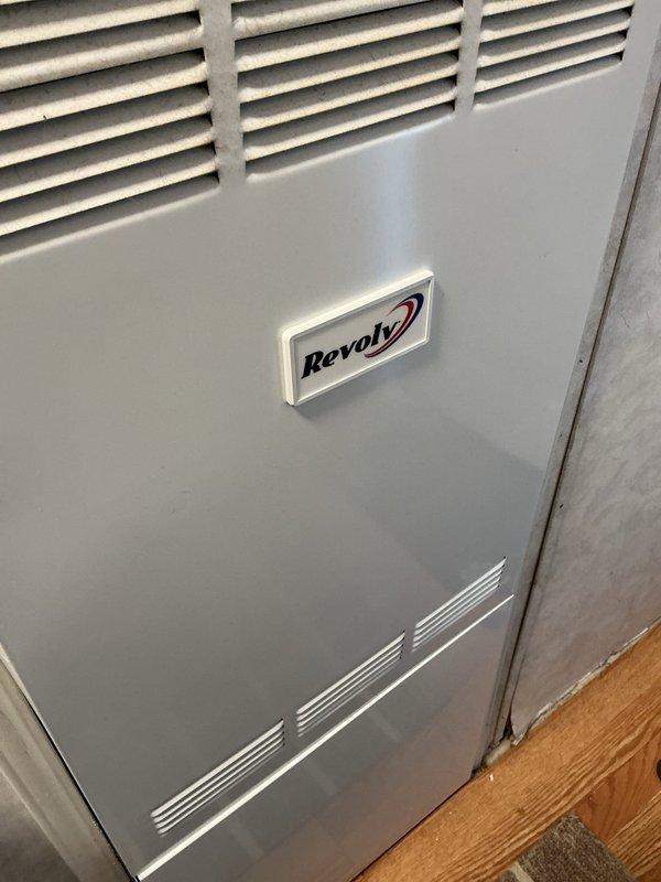 Completed warranty callback on Revolv furnace unit. Successfully replaced front door nameplate with correct manufacturer branding. Door latch replacement could not be completed due to incorrect part received; submitted new part request for proper latch component to complete warranty repair.