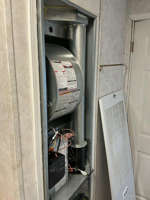 Completed warranty callback on Revolv furnace unit. Successfully replaced front door nameplate with correct manufacturer branding. Door latch replacement could not be completed due to incorrect part received; submitted new part request for proper latch component to complete warranty repair.