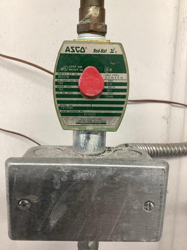 Responded to emergency service call for irrigation water interruption issue. Upon inspection, diagnosed a failing ASCO Red-Hat II two-way solenoid valve assembly that was preventing proper water flow to the irrigation system. Removed the defective solenoid valve unit, including the green and cream-colored control mechanism with junction box and associated electrical connections. Installed straight pipe section to bypass the failed valve assembly and restore direct water flow to the irrigation system. Verified proper water flow and system operation upon completion.