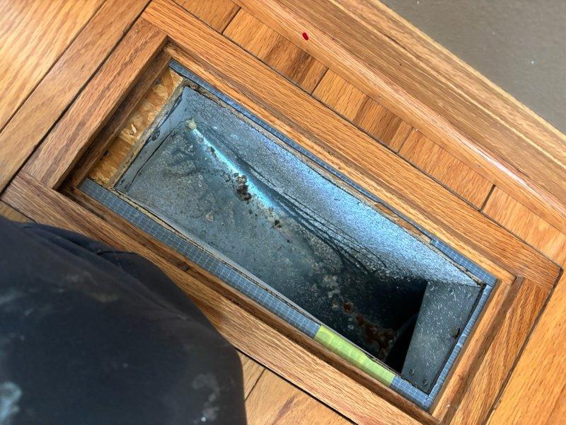 Completed comprehensive duct cleaning service on residential HVAC system with 27 total openings including both supply and return ducts. Removed significant accumulation of lint and debris throughout the ductwork system and cleaned all vent registers. Identified one open vent requiring 13x9 cover for proper system operation and noted floor register showing corrosion and moisture damage requiring attention.