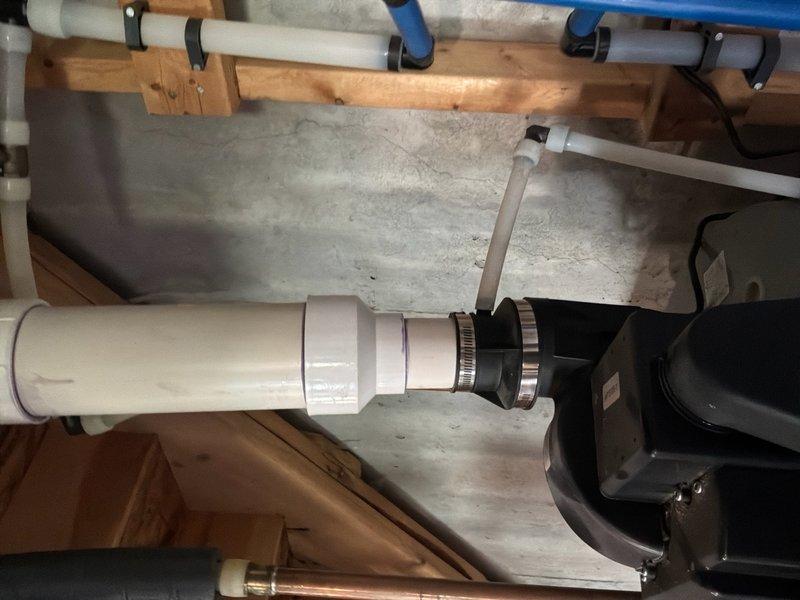 Responded to service call for 50-gallon natural gas power vent water heater manufactured in 2017 experiencing active leak from bottom of unit. Upon inspection, confirmed water leakage originating from base of tank due to cracked internal liner, indicating tank failure. Documented existing installation including power vent motor assembly, PVC venting system, and copper supply lines. Photographed mechanical components and piping configuration for replacement estimate purposes. Provided comprehensive estimate for complete water heater replacement due to non-repairable tank failure.