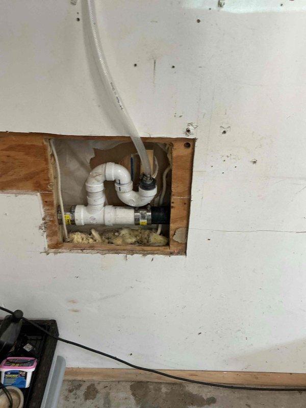 Installed a proper P-trap on the HVAC condensate drain line to replace the temporary drainage setup. The condensate line was previously running directly to the drain without appropriate trap configuration. Completed installation of code-compliant P-trap assembly using white PVC piping with proper fittings to ensure adequate drainage and prevent air infiltration into the system.